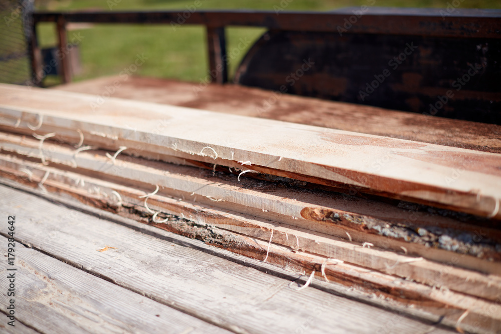 Freshly cut rough sawed planks of lumber Freshly cut rough sawed planks of lumber