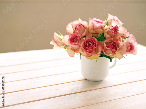 Bouquet of pink roses in white mug