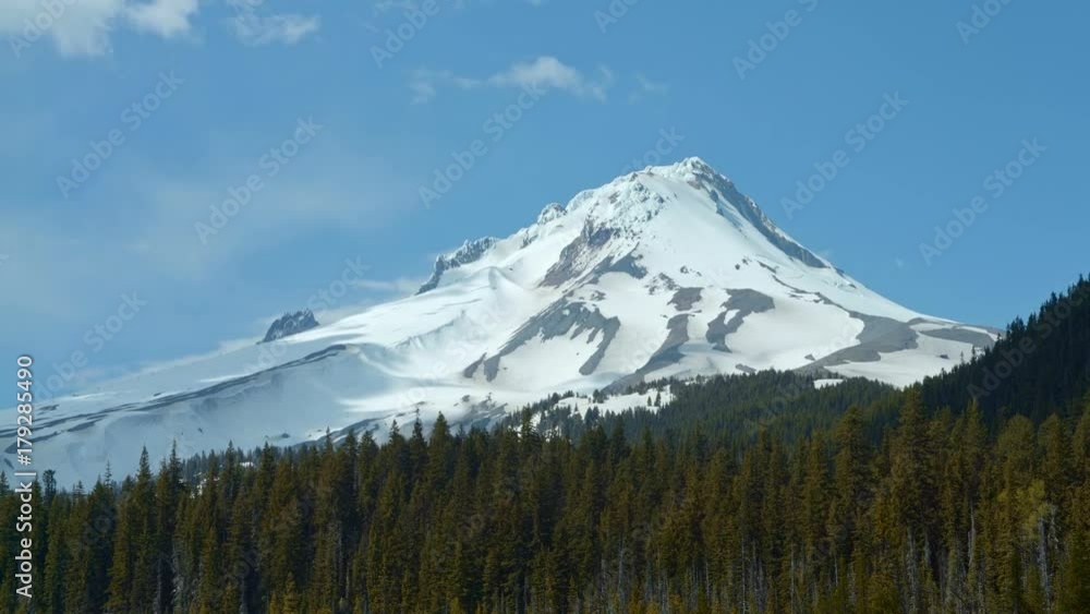 Snowy mountain peak and evergreen forest with shadows time lapse Mt. Hood Spring Forest Oregon Cascade Mountains