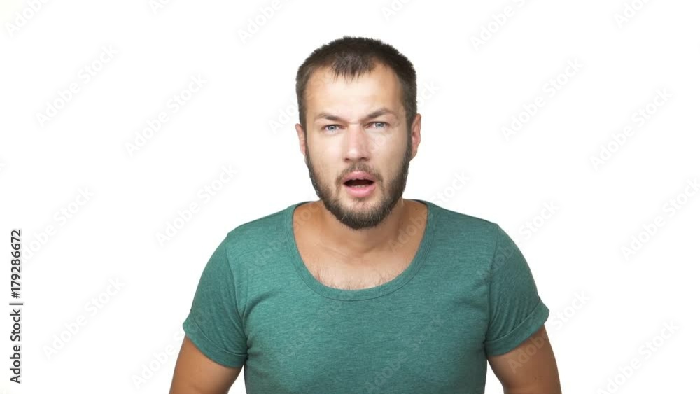 slowmotion horizontal portrait of handsome displeased guy with short brown hair being surprised frustrated expressing outrage confusion over white background closeup. Concept of emotions slowmotion horizontal portrait of handsome displeased guy with short brown hair being surprised frustrated expressing outrage confusion over white background closeup. Concept of emotions