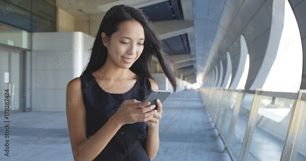 Fototapeta premium Woman use of mobile phone at outdoor