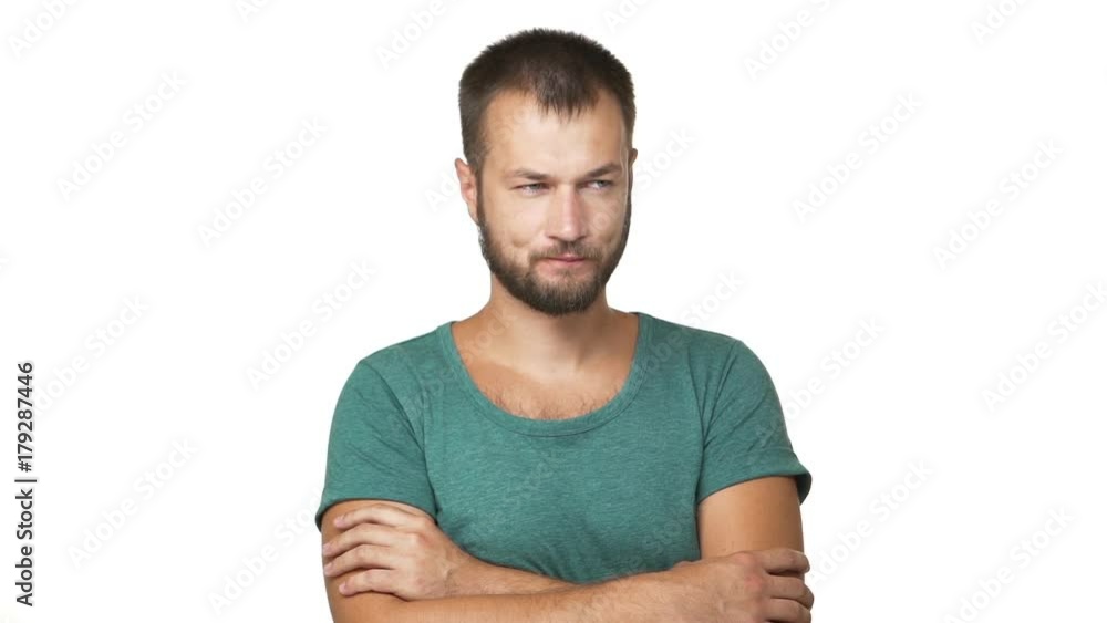 slow motion portrait of caucasian adult dark-haired guy standing with crossed hands thinking hard touching his beard reflecting trying to remember over white background closeup. Concept of emotions slow motion portrait of caucasian adult dark-haired guy standing with crossed hands thinking hard touching his beard reflecting trying to remember over white background closeup. Concept of emotions