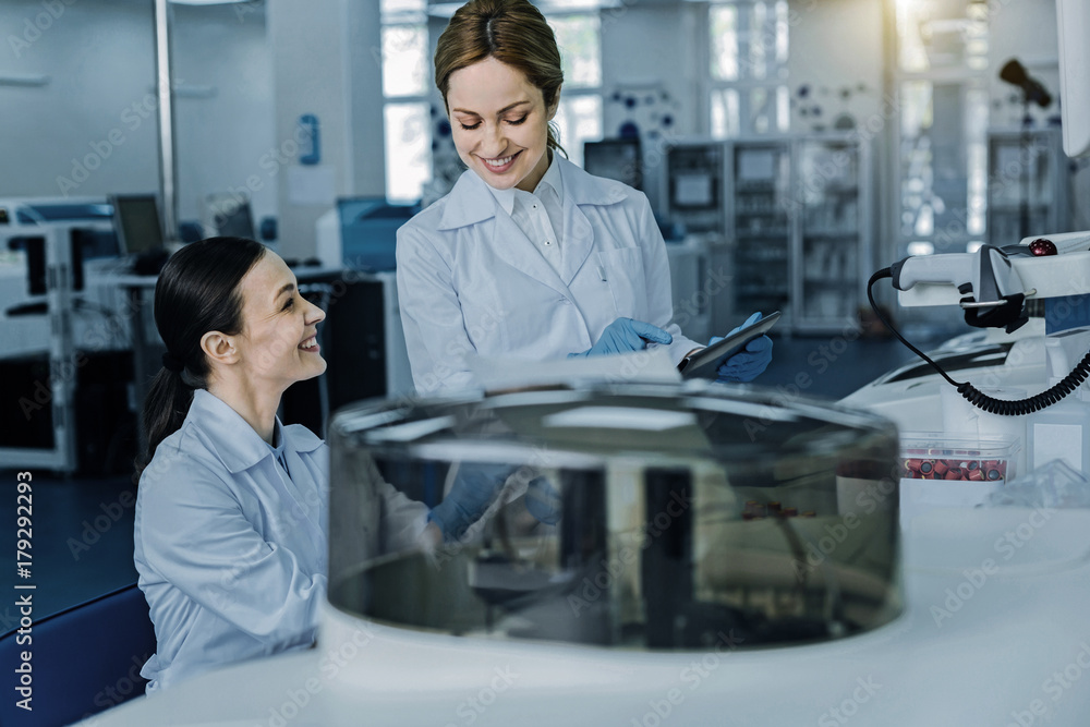 Ready to start. Cheerful happy delighted scientist smiling and being a ready to start while performing a test Ready to start. Cheerful happy delighted scientist smiling and being a ready to start while performing a test