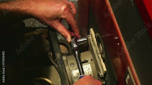 Screwing off gas burner flange screws before unmouting burner from furnace. Doing service on home gas burner heater. In slow motion hd.
