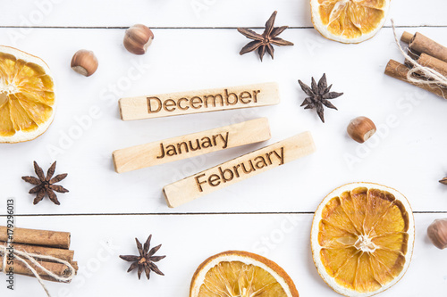 winter still life with the inscriptions of the names of the months - December, January, February among the Christmas products and ornaments. Flat lay