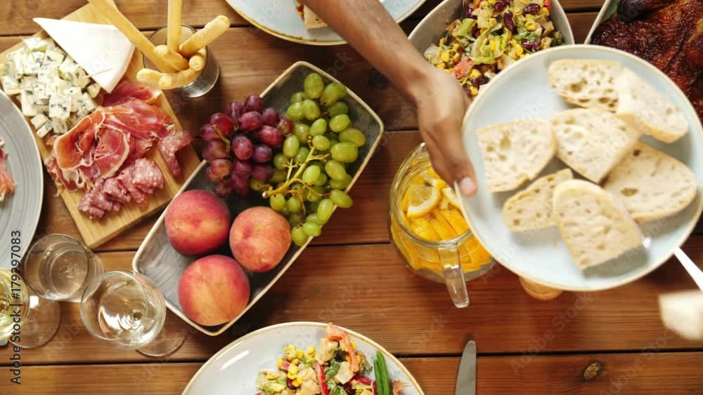 group of people eating at table with food