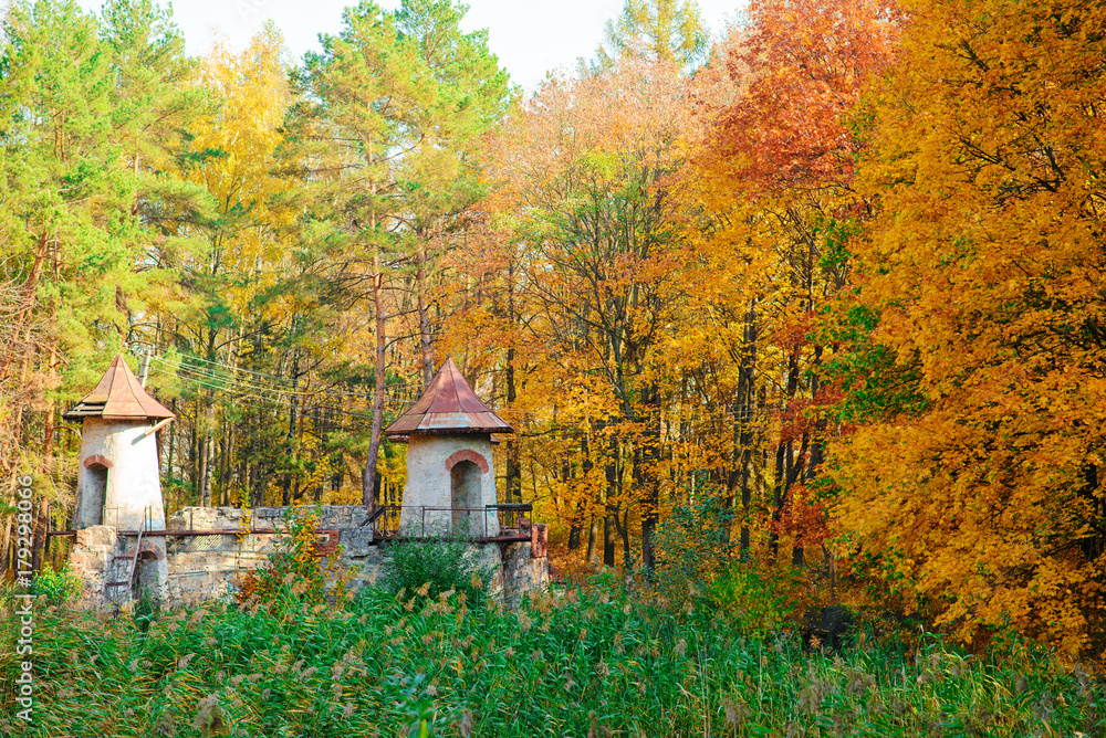 An old ruined and empty castle in the middle of the autumn forest