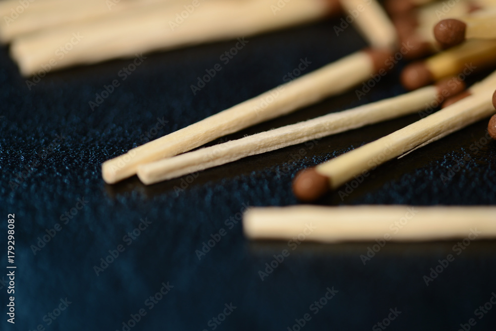 Scattered matches on dark background close up Scattered matches on dark background close up