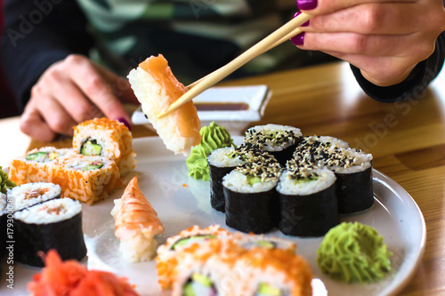 sushi and rolls, Japanese cuisine, a girl eating sushi