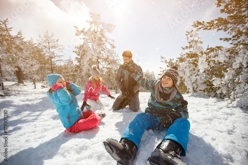 Family having fun on snow in mountain at winter