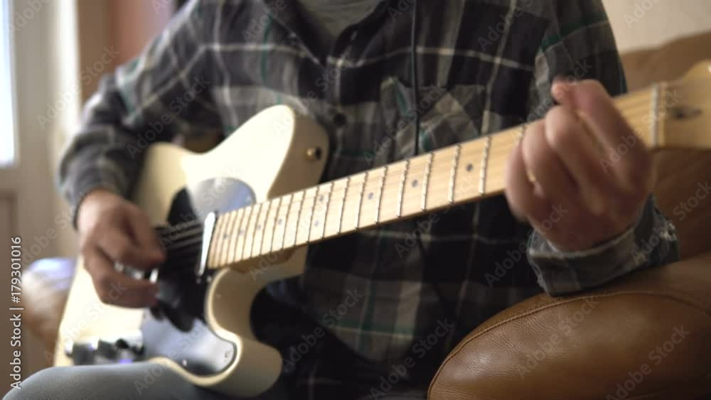 Home recording musician series. A young guy improvising on the guitar Home recording musician series. A young guy improvising on the guitar