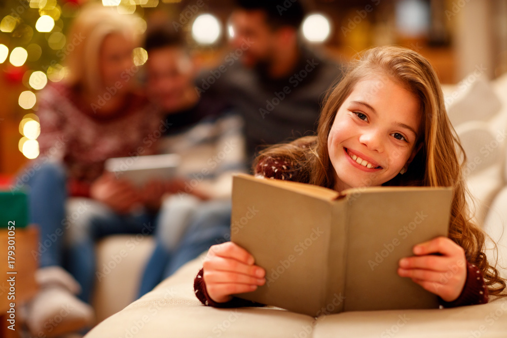 little girl lying and reading children book for Christmas. little girl lying and reading children book for Christmas.