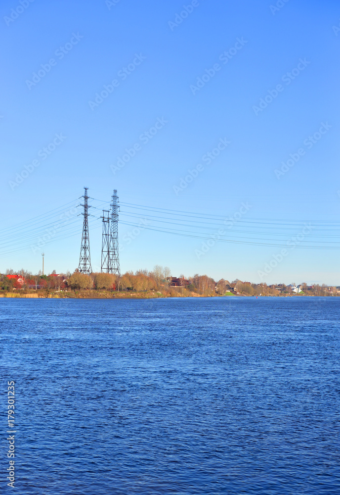 Power line and Neva River at autumn.