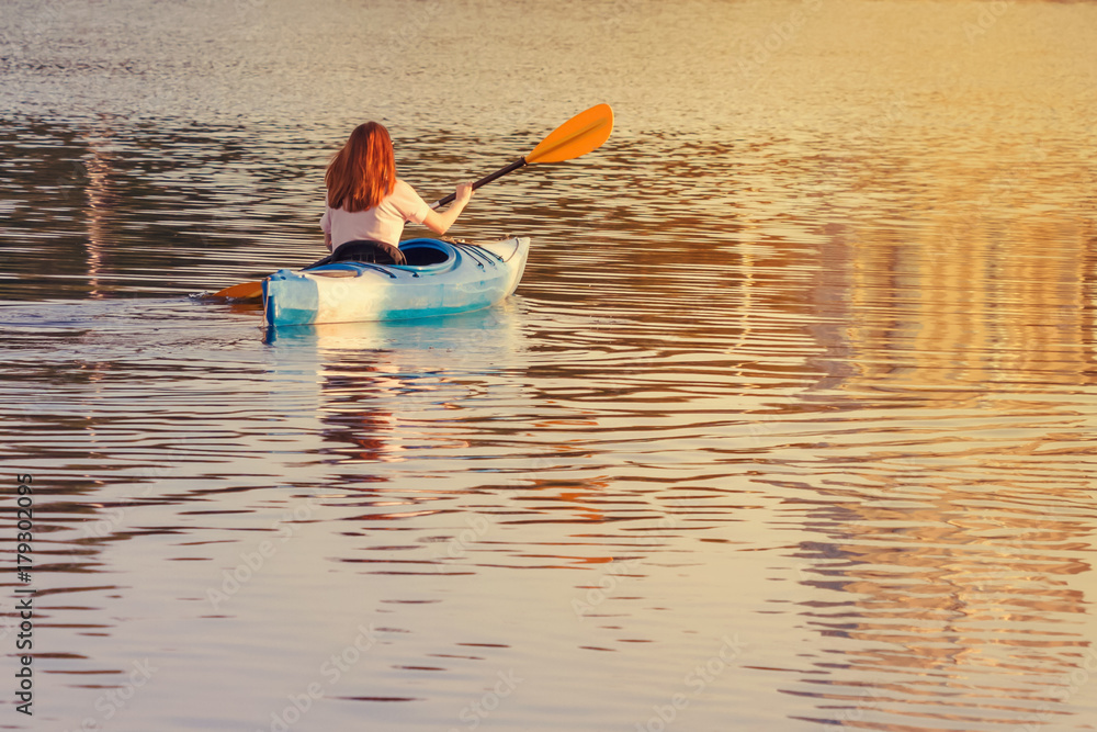 A girl in a blue kayak