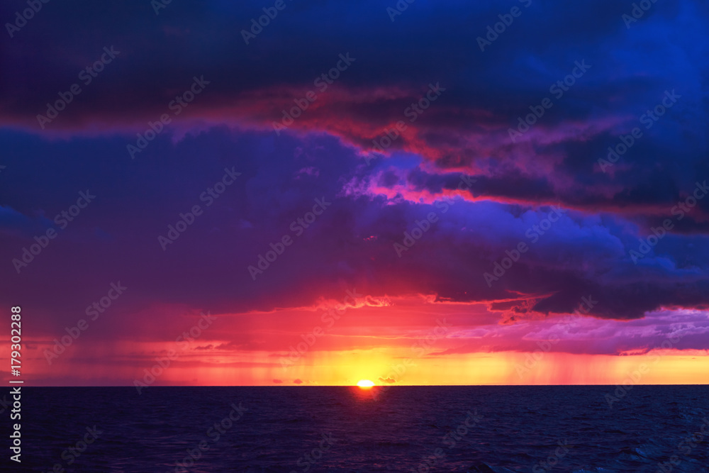 Natural Purple Color Sunset Or Sunrise Sky Over Stormy Rainy Sea