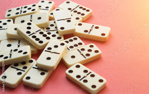 Dominoes on Pink background. Flat lay