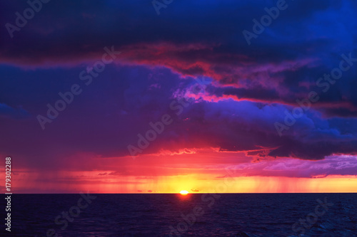 Natural Purple Color Sunset Or Sunrise Sky Over Stormy Rainy Sea