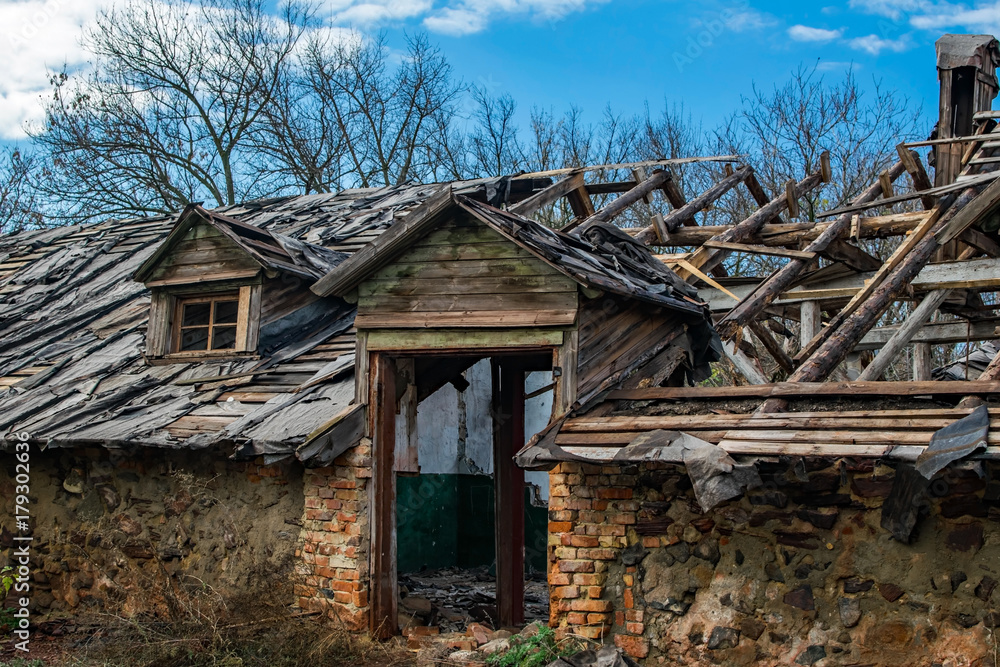 An old abandoned ruined wooden building. Broken doorway An old abandoned ruined wooden building. Broken doorway