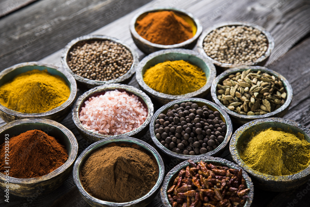 Spices and herbs in wooden bowls. Food and cuisine ingredients