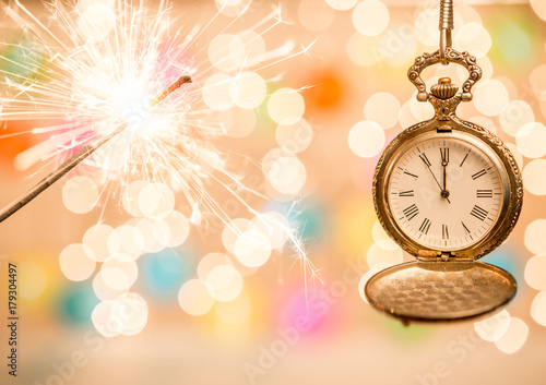 Sparker and clock as holiday background