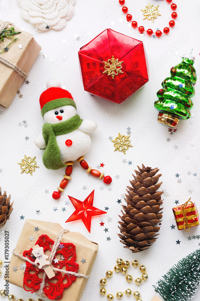 Christmas background with decorations. New Year symbol - decorative fir tree. Gifts in craft paper, pine cones and confetti. Flay lay, top view. Christmas background with decorations. New Year symbol - decorative fir tree. Gifts in craft paper, pine cones and confetti. Flay lay, top view.