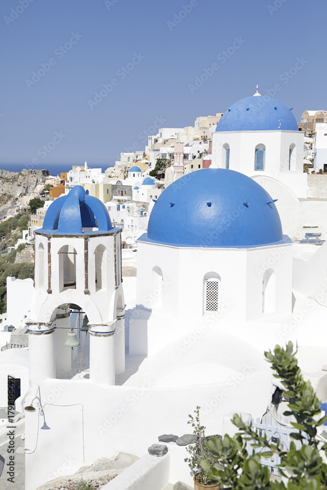 Churches with blue domes in Oia town on Santorini island, Greece