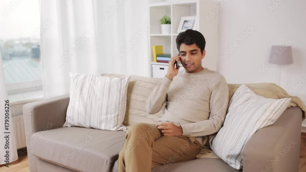 happy man calling on smartphone at home happy man calling on smartphone at home