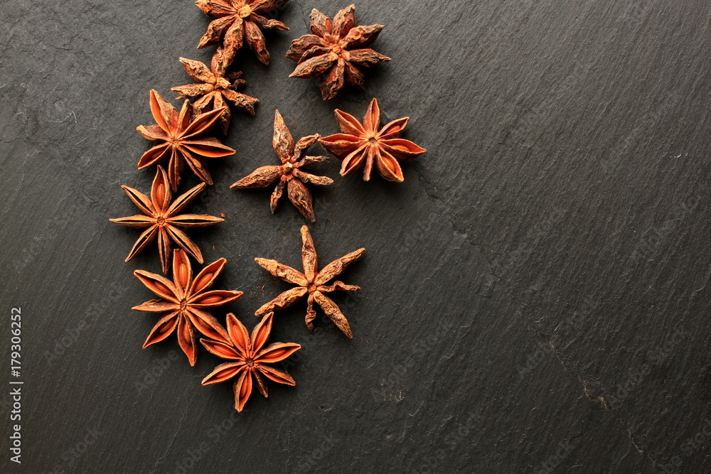 Star anise on black background with space for your message