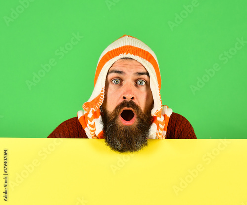 Guy with surprised face on green and cyan background