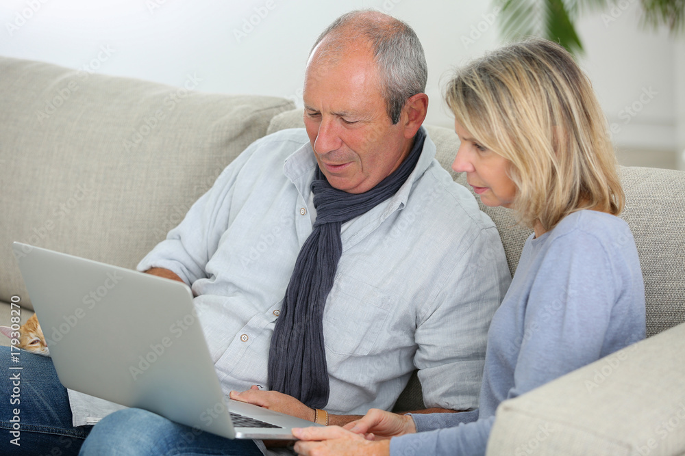 senior couple using computer senior couple using computer
