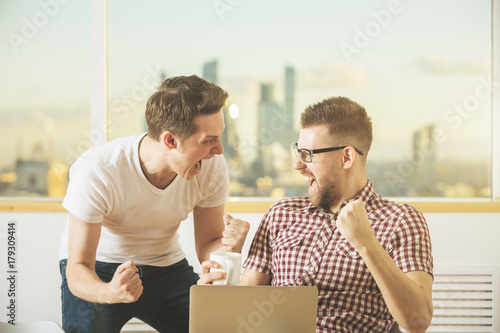 Attractive businessmen celebrating success