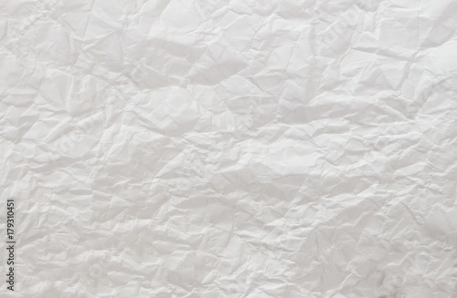 Crumpled white paper background.