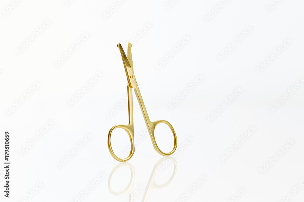 Close up set of gold scissors on black background Close up set of gold scissors on black background