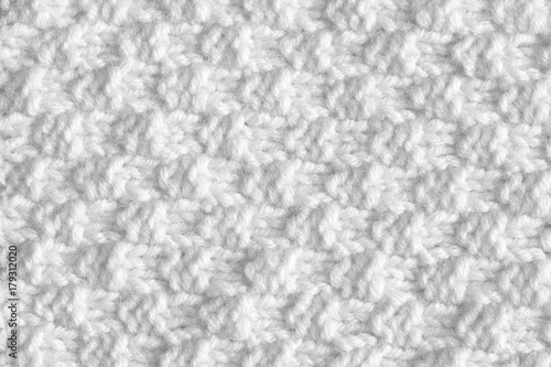 Knitted white woolen thread background. The texture of the nap is handmade.