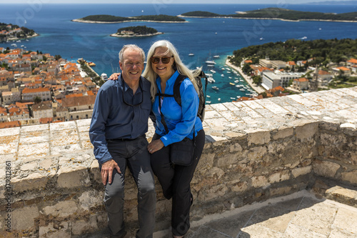 Caucasian couple posing near scenic view of ocean