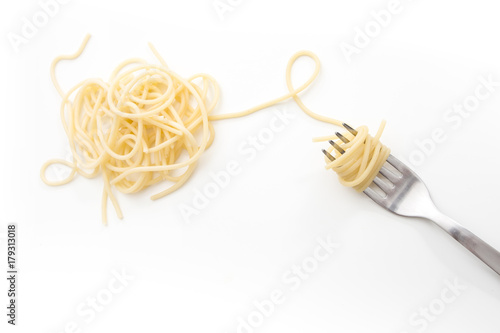 Plain cooked spaghetti pasta on fork, on white background.