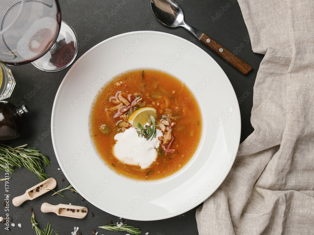 Brown soup in bowl with sour cream Brown soup in bowl with sour cream