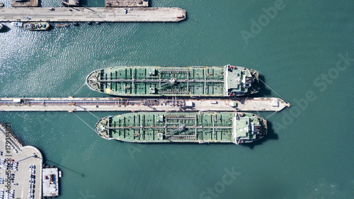 Aerial shot of two tanker ships anchored at the oil terminal at port