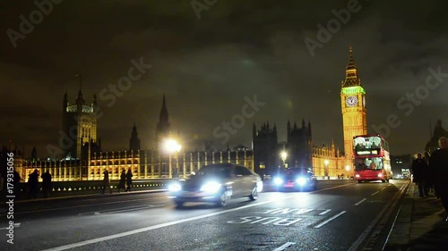 Busy streets along the streets of Big Ben and Wesminster bridge at night photo