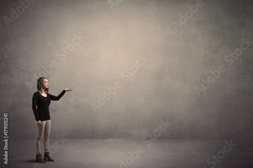 Woman standing in front of a blank wall