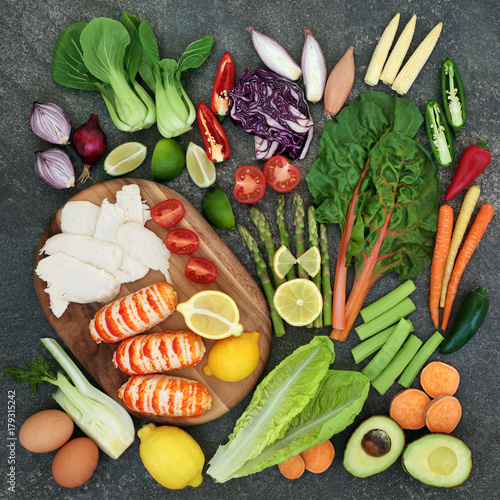 Diet health food concept with high protein meat and fish, vegetables, fruit, and dairy. Super food high in omega 3, antioxidants, anthocyanins, vitamins and fibre.Top view.
