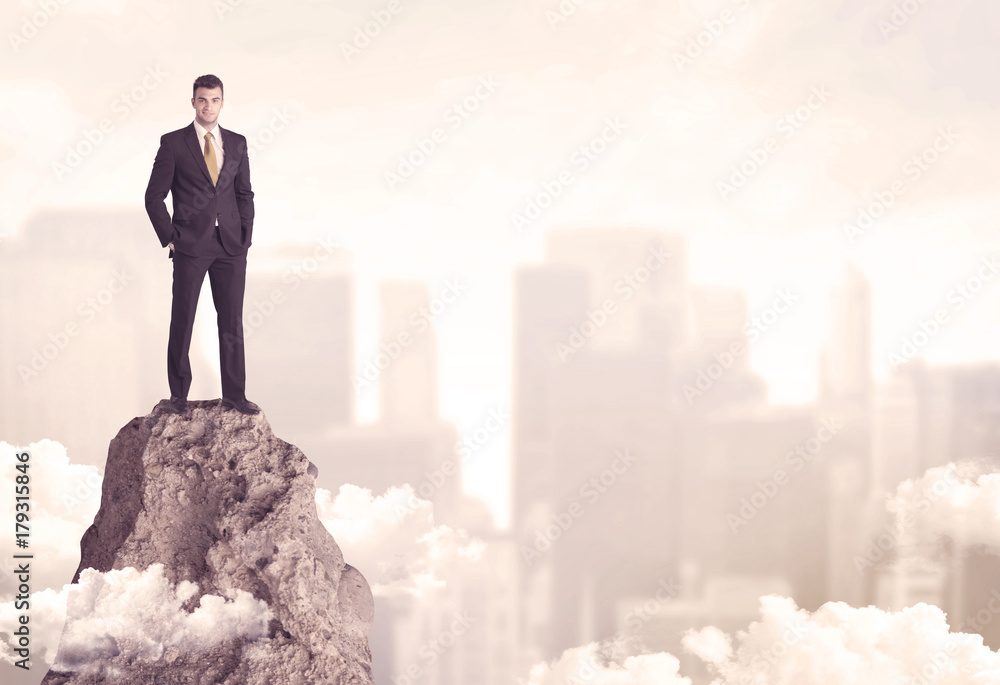 Confident businessman on dangerous cliff Confident businessman on dangerous cliff