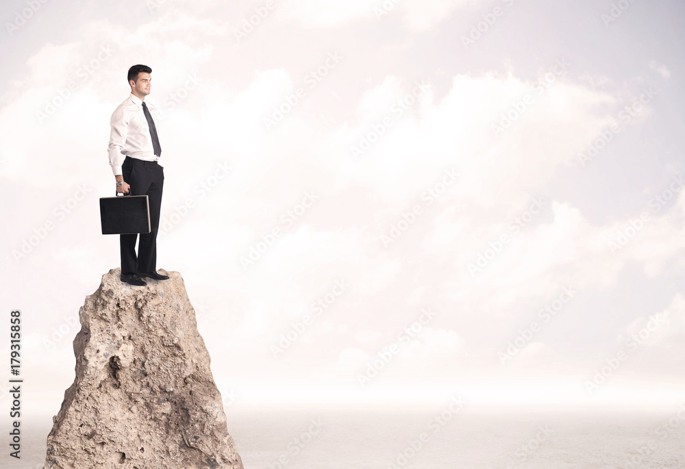 Happy businessman standing on cliff Happy businessman standing on cliff