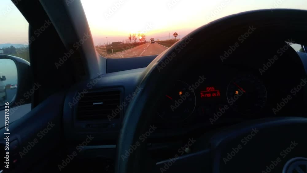 Personal perspective of driving a car with express road disappearing over the horizon to the sun Personal perspective of driving a car with express road disappearing over the horizon to the sun