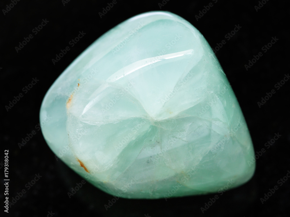 Fototapeta premium polished Prehnite gemstone on dark background