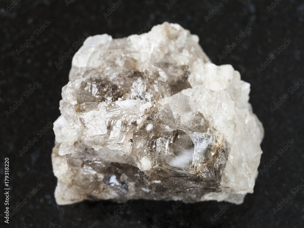 raw Halite (rock salt) stone on dark background raw Halite (rock salt) stone on dark background