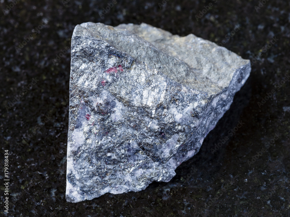 raw antimonite stone on dark background raw antimonite stone on dark background