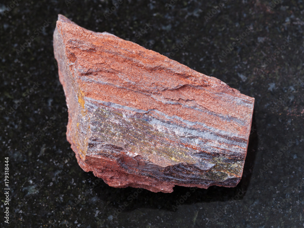 rough ferruginous quartzite stone on dark