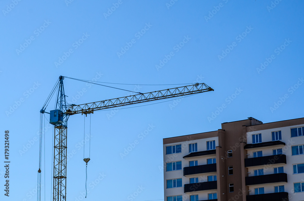 High construction crane against blue sky