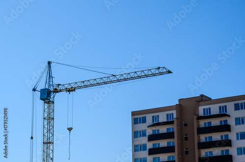 High construction crane against blue sky